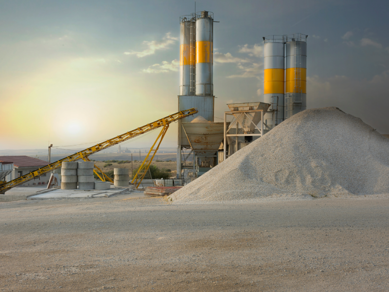 A factory and a large pile of sand.