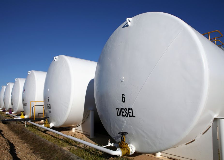 Several large white diesel tanks.